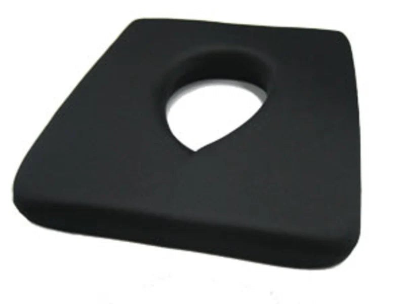 Black square object with a circular indentation on a white background