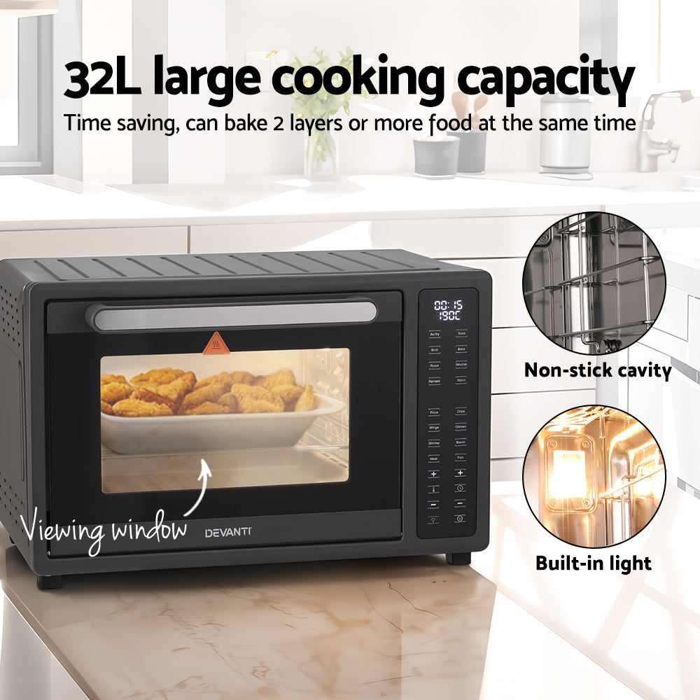 Black Devanti toaster oven with viewing window on a kitchen counter, showing food inside.