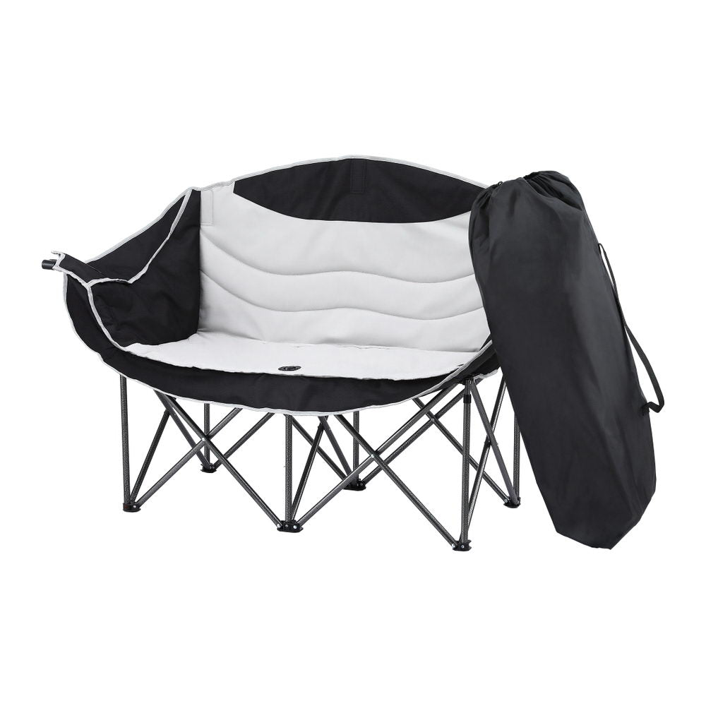 Black and white folding chair with carrying bag on a white background