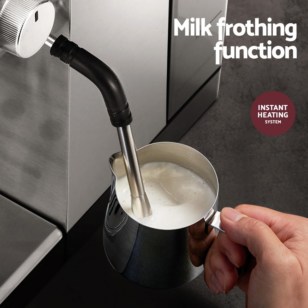 Milk frothing function being used with a handheld milk frother attached to a coffee machine.