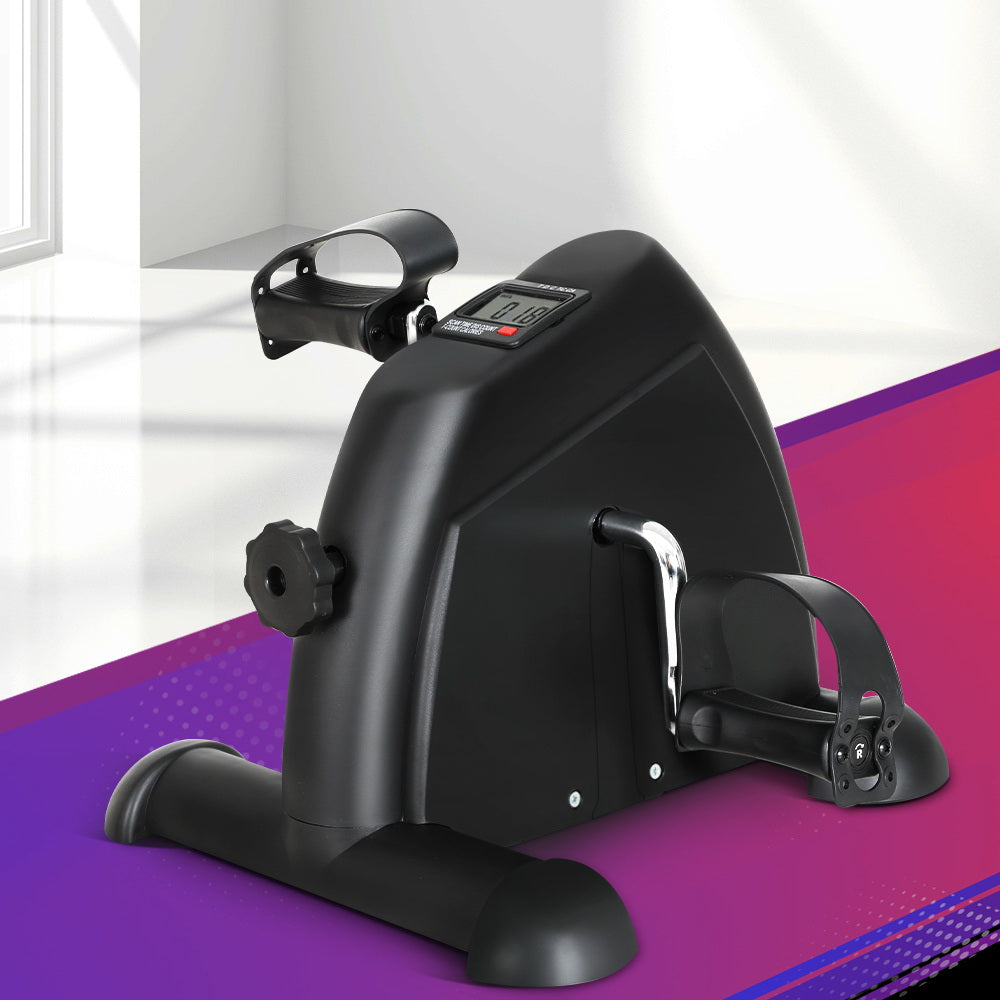 Black exercise bike on a purple and white background