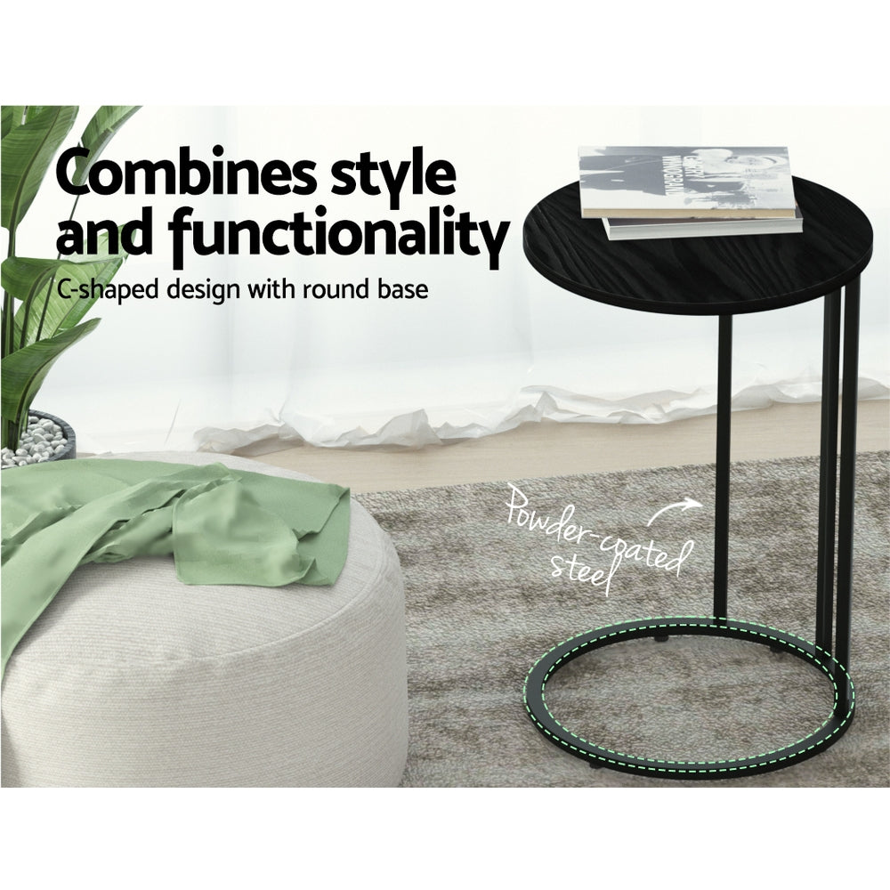 Black side table with round base in a room setting, featuring text about style and functionality.