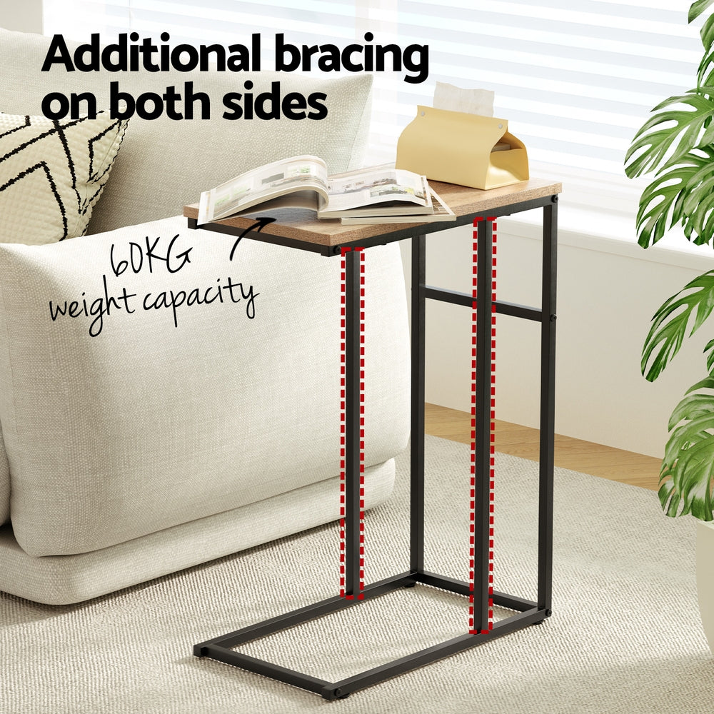 Small side table with additional bracing on both sides in a living room setting.