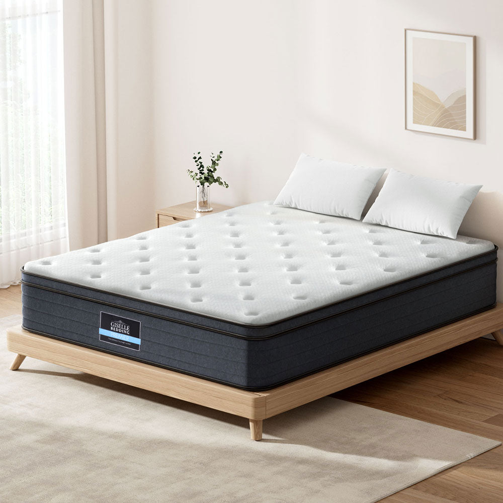 Mattress on a wooden bed frame in a bedroom setting with a neutral color scheme.