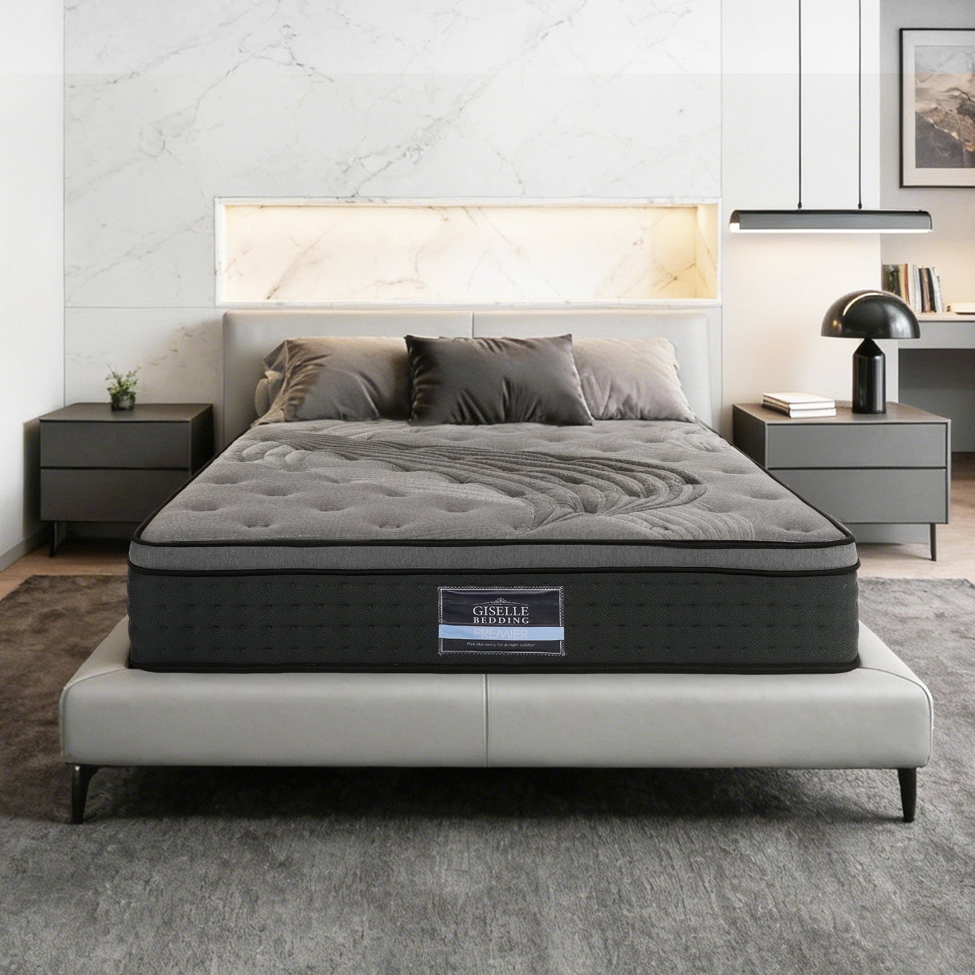 Gray mattress on a bed in a bedroom setting with nightstands and decor.