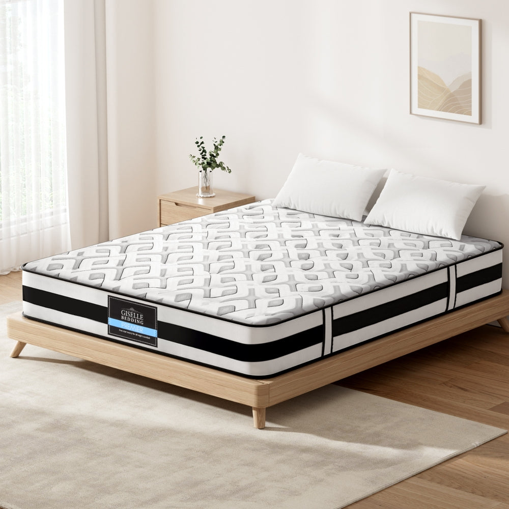 Mattress on a wooden bed frame in a bedroom setting with a visible brand label.