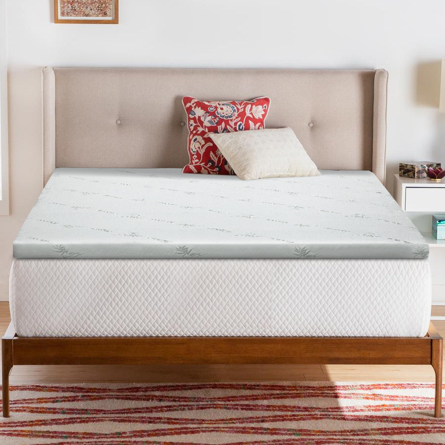 Mattress topper on a bed with pillows in a bedroom setting