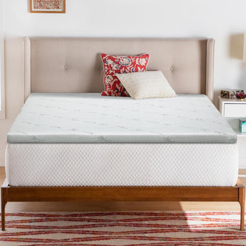 Mattress topper on a bed with pillows in a bedroom setting