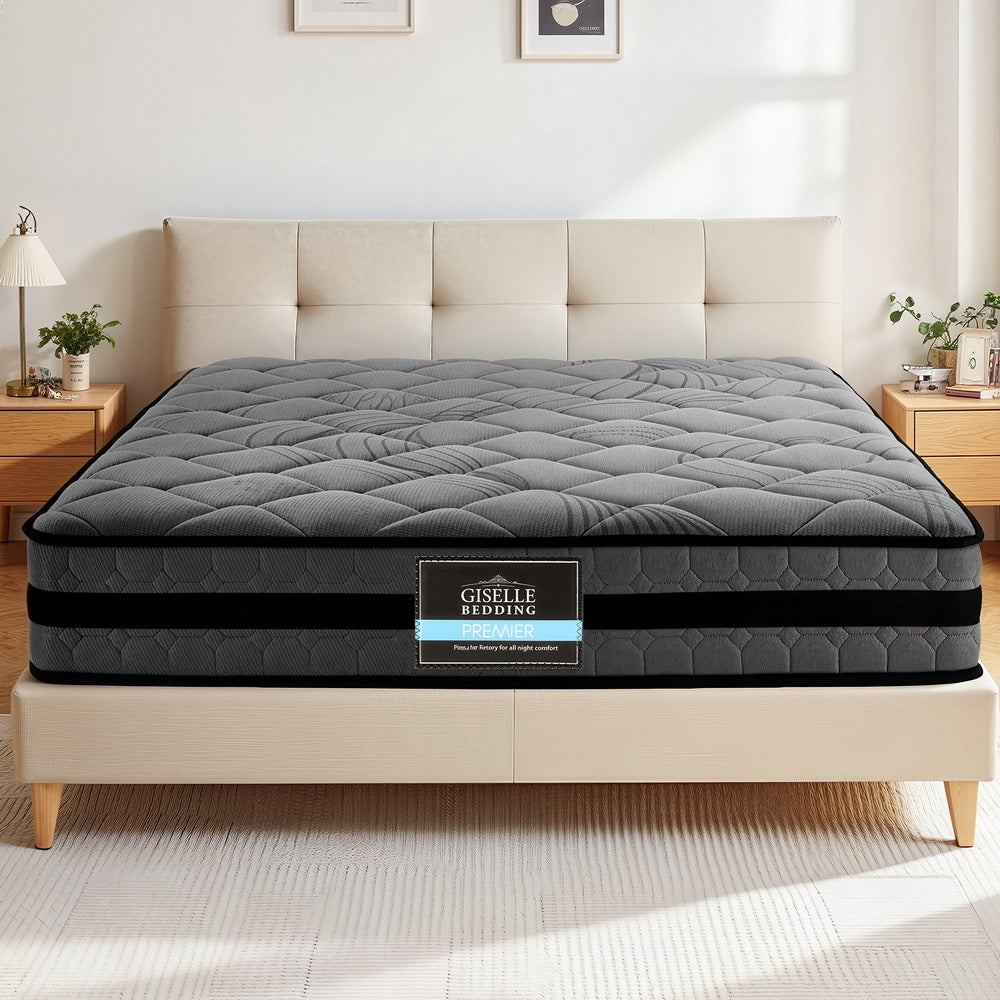 Gray mattress on a bed with Giselle Bedding logo in a bedroom setting