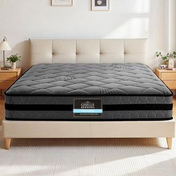 Gray mattress on a bed with Giselle Bedding logo in a bedroom setting