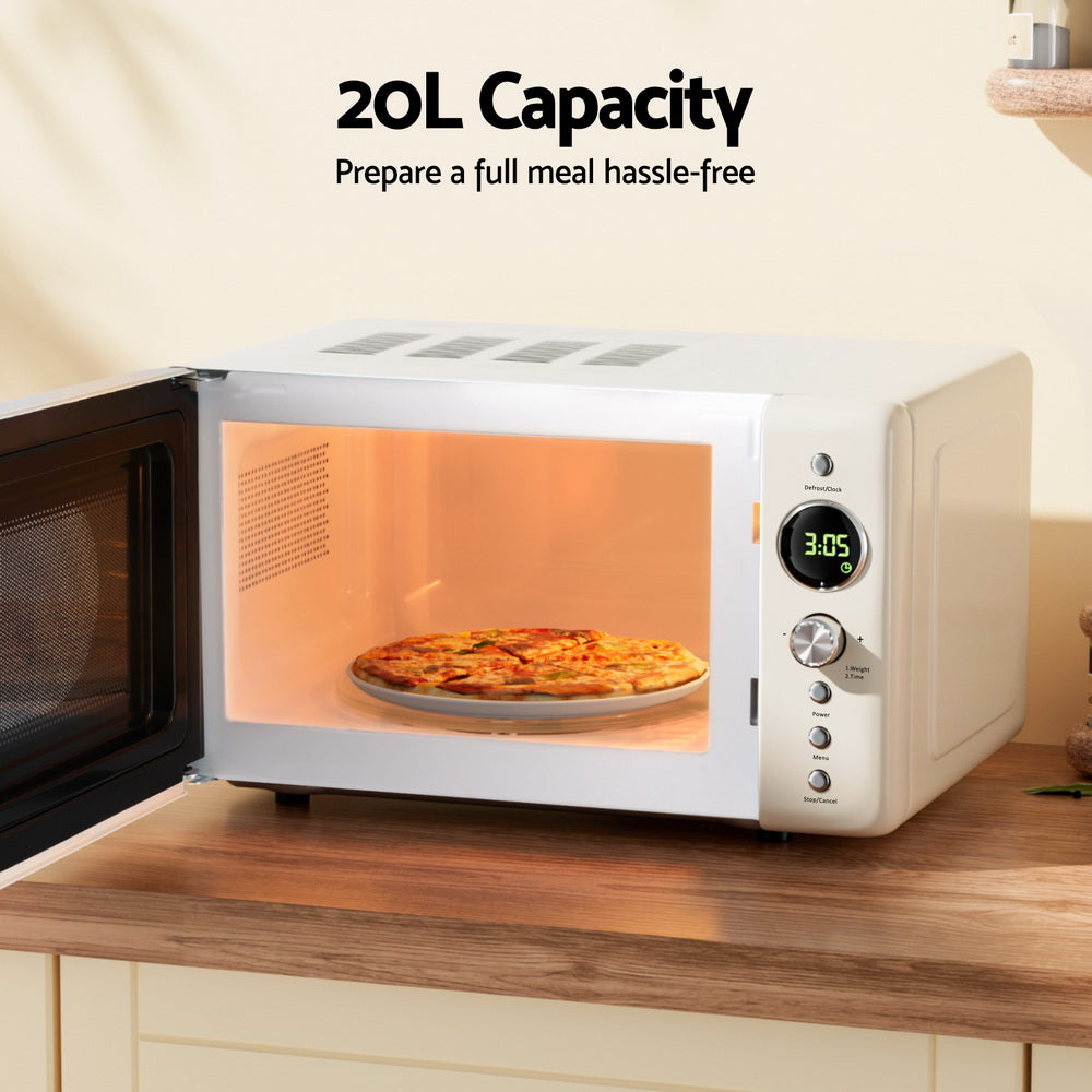 White microwave oven with pizza inside on a wooden countertop, labeled '20L Capacity'.