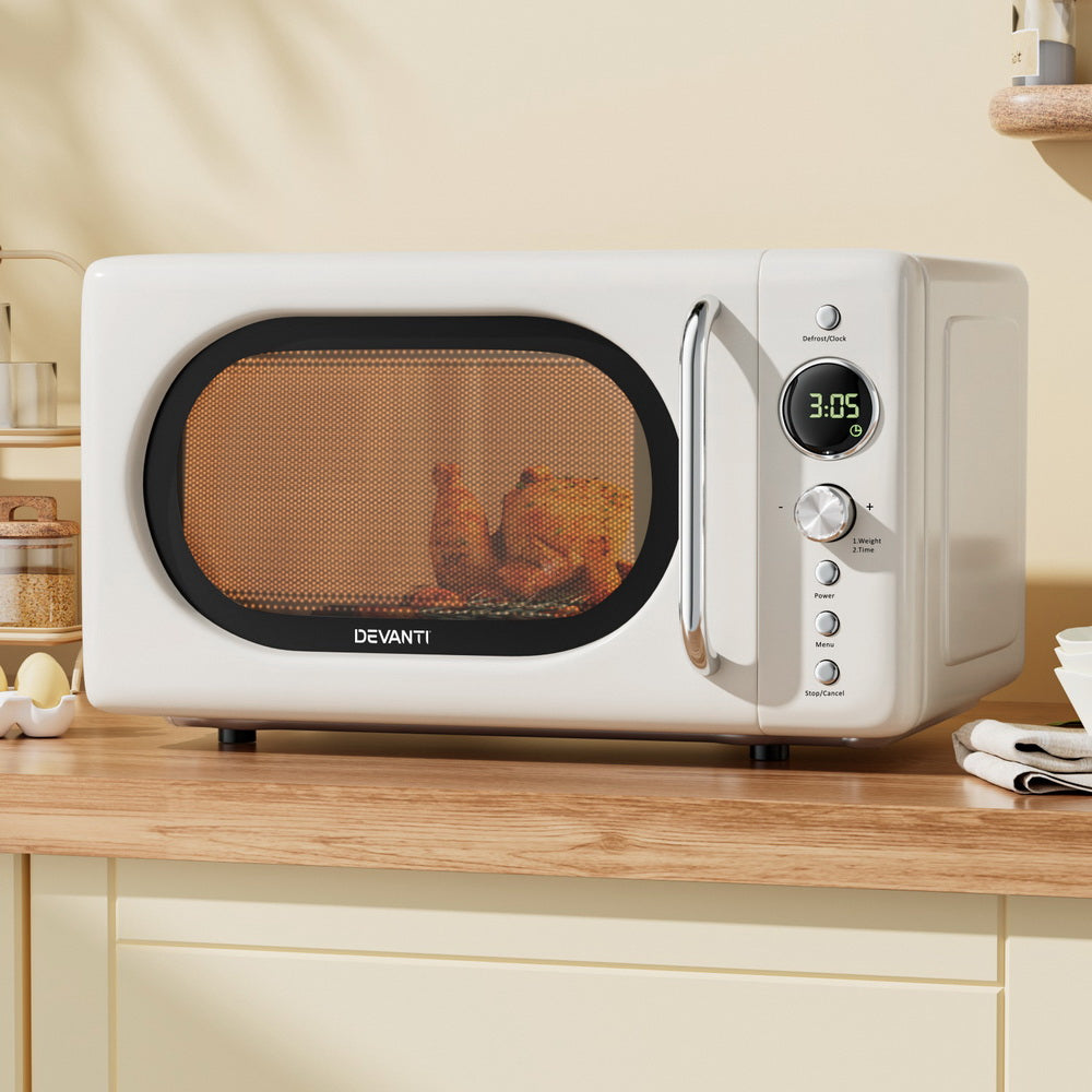 White microwave oven with digital display on a kitchen counter, featuring the brand 'Devanti'.