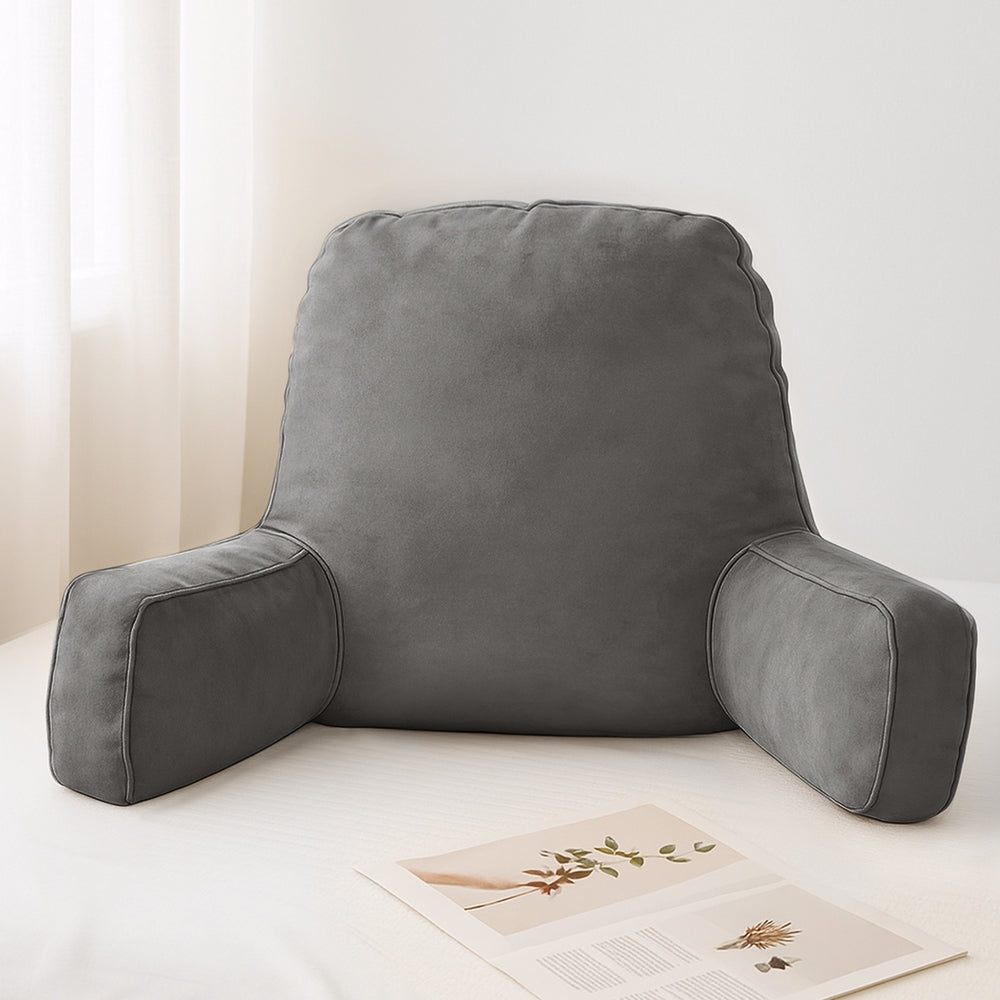 Gray backrest pillow on a white surface with a light background