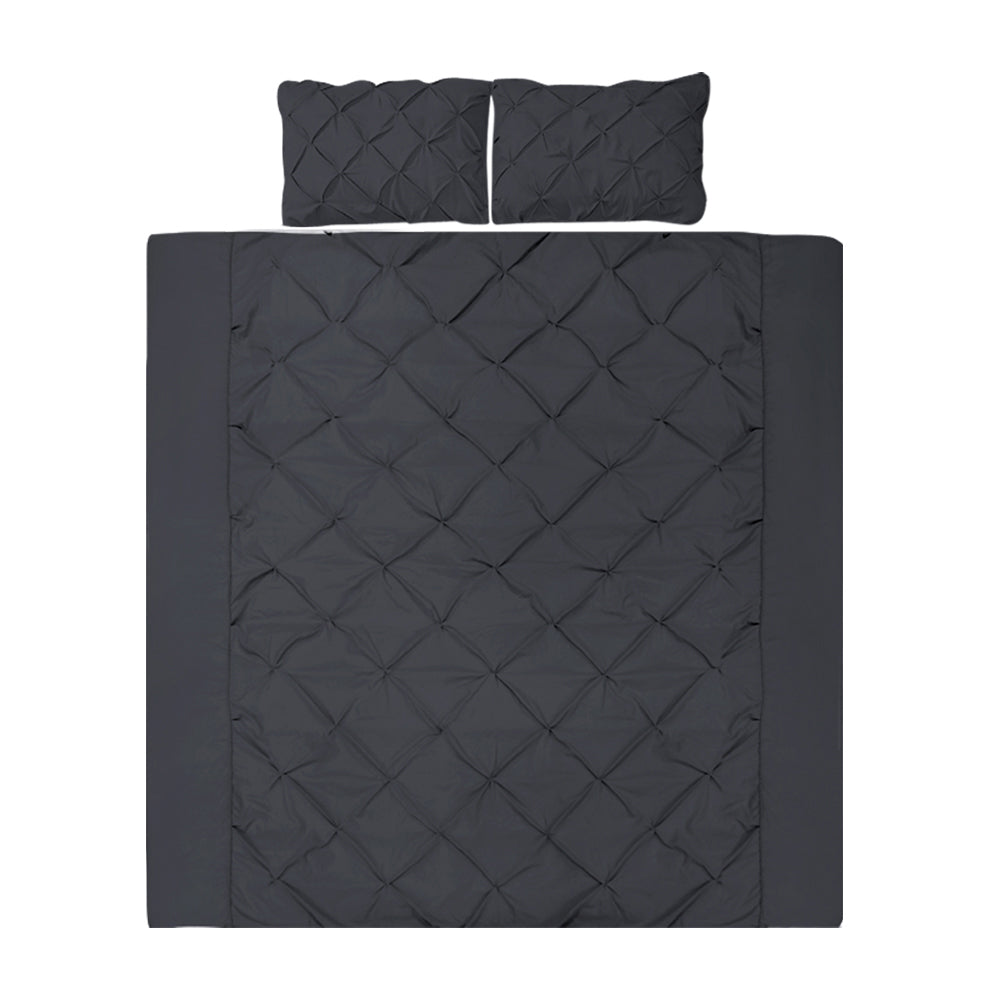 Black quilted bedding set with two pillows on a white background