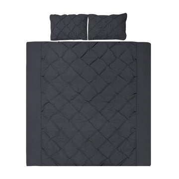 Black quilted bedding set with two pillows on a white background