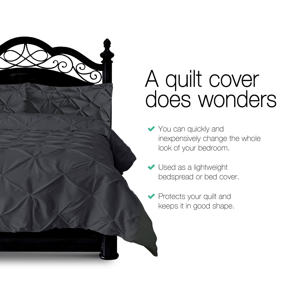 Gray quilt cover on a bed with text highlighting its benefits