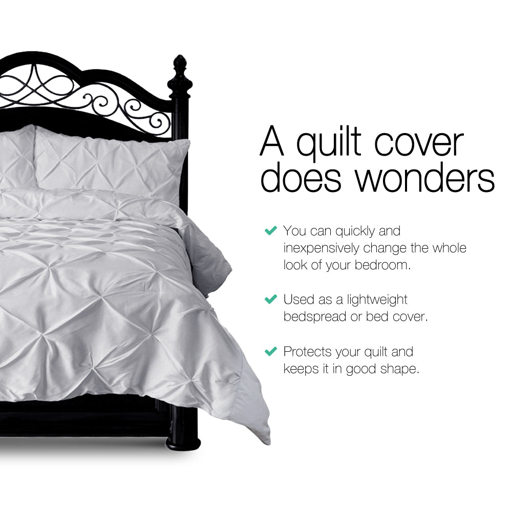 White quilt cover on a bed with text highlighting its benefits