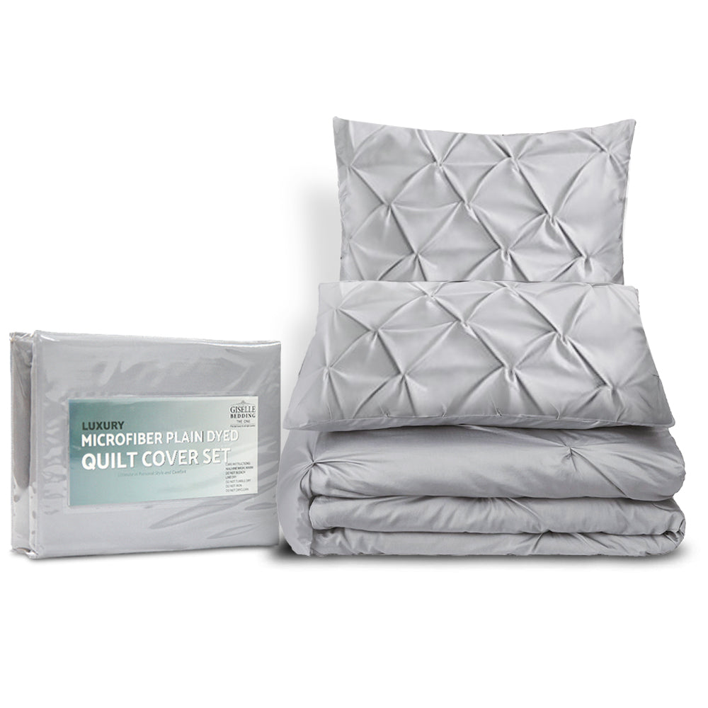 Gray quilt cover set with pillow and packaging on a white background