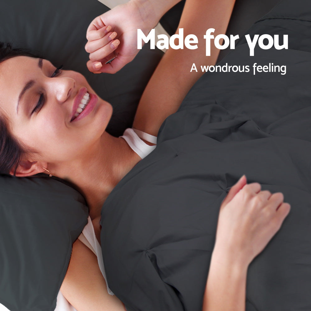Woman lying in bed with a black comforter, smiling with 'Made for you' text above.