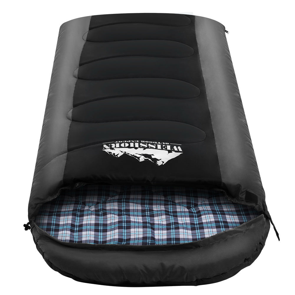 Black inflatable sleeping pad with plaid interior on a white background