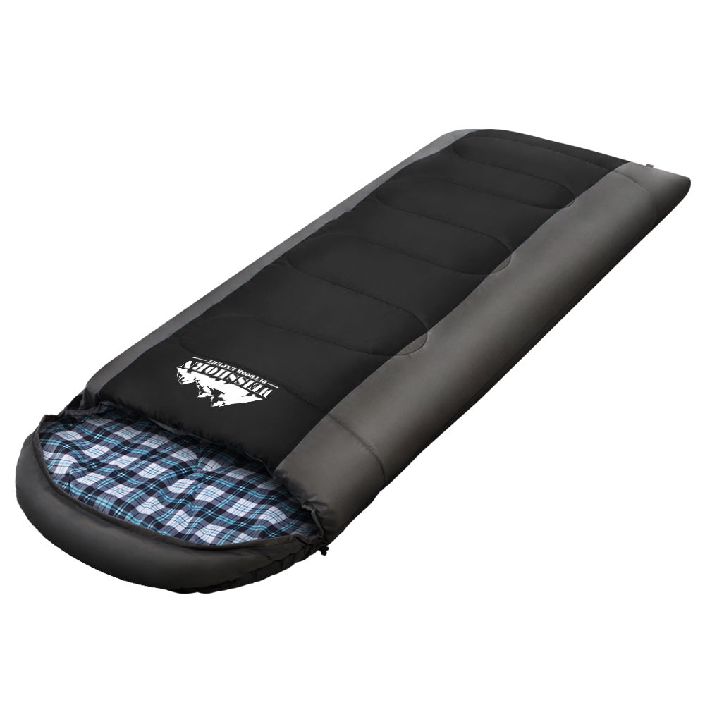 Black sleeping bag with blue plaid interior on a white background