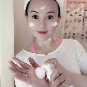 Person holding a white ball with a decorative background