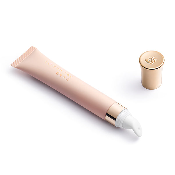 Cosmetic tube with pump and gold cap on a white background