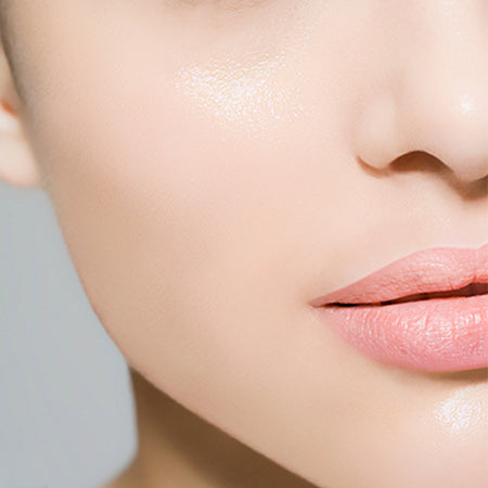 Close-up of a person's lips with a neutral background
