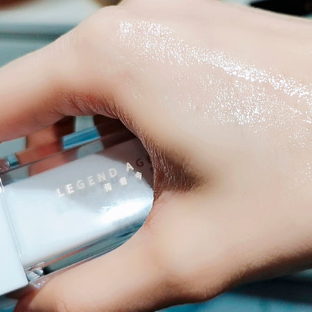 Hand applying a cosmetic product with 'Legend A' branding.