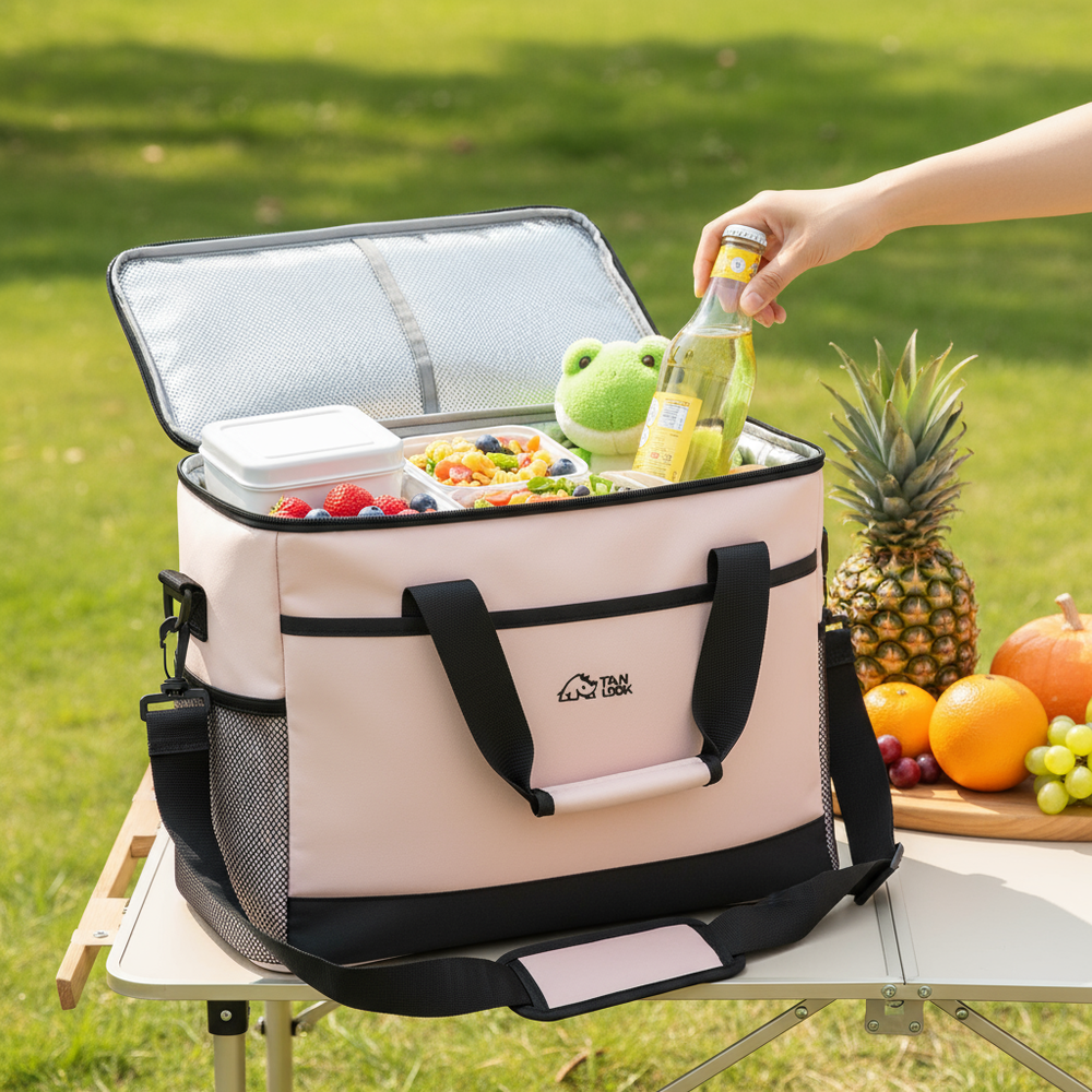 Cooler bag with food items on a picnic table outdoors