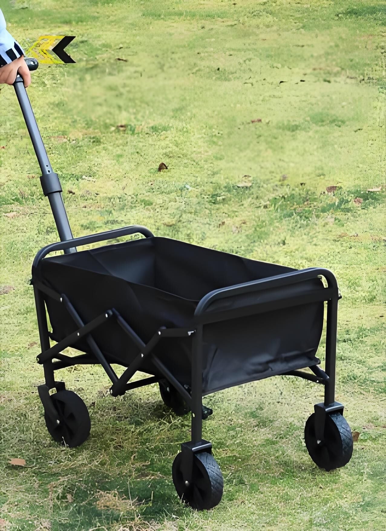 Black folding cart on grass