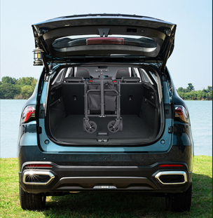 SUV with open trunk showing a bike rack by a body of water