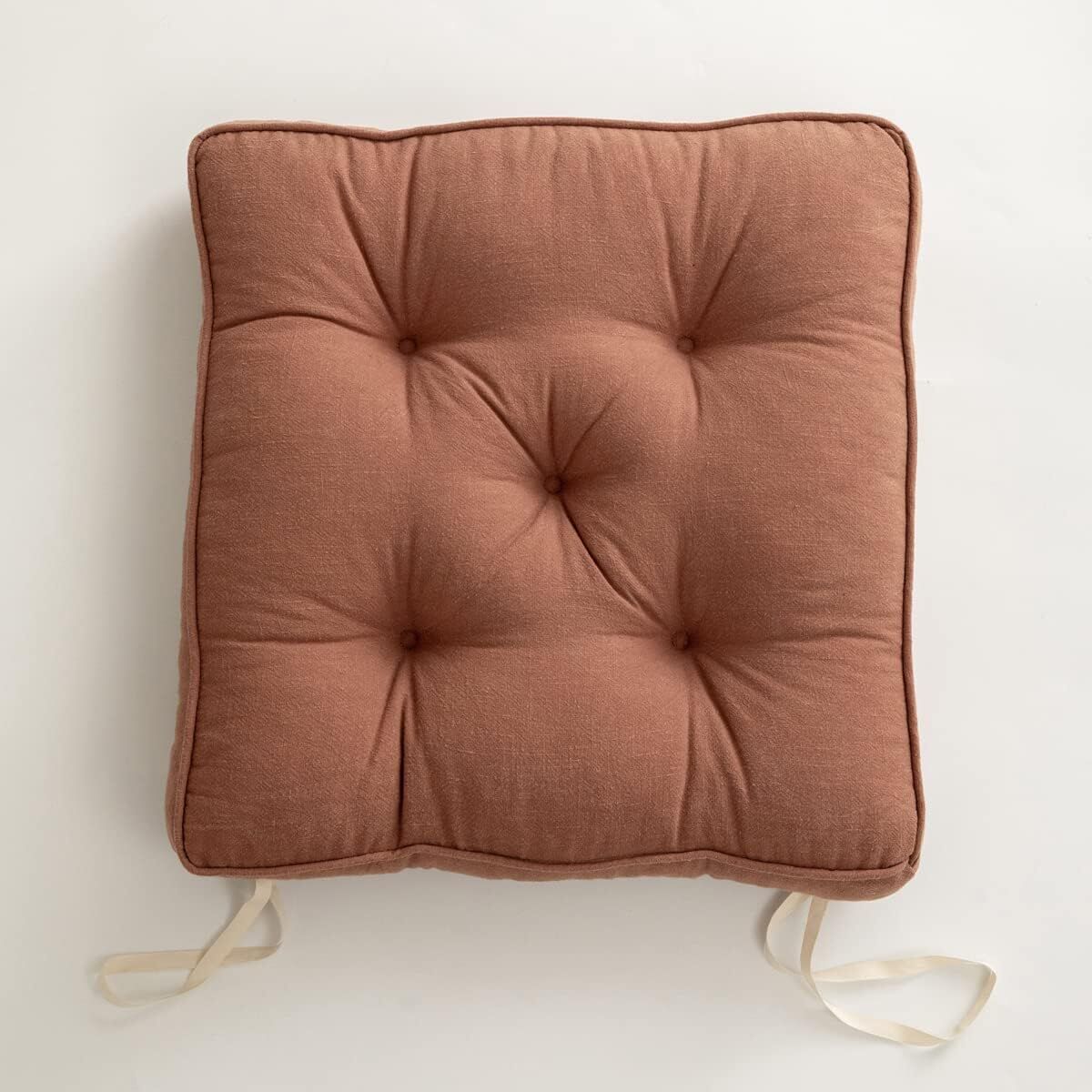 Brown cushion with straps on a white background