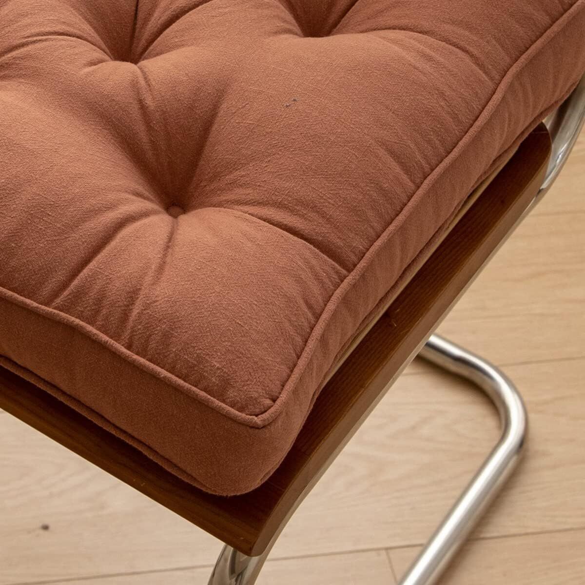 Brown cushion on a chair with a wooden floor background