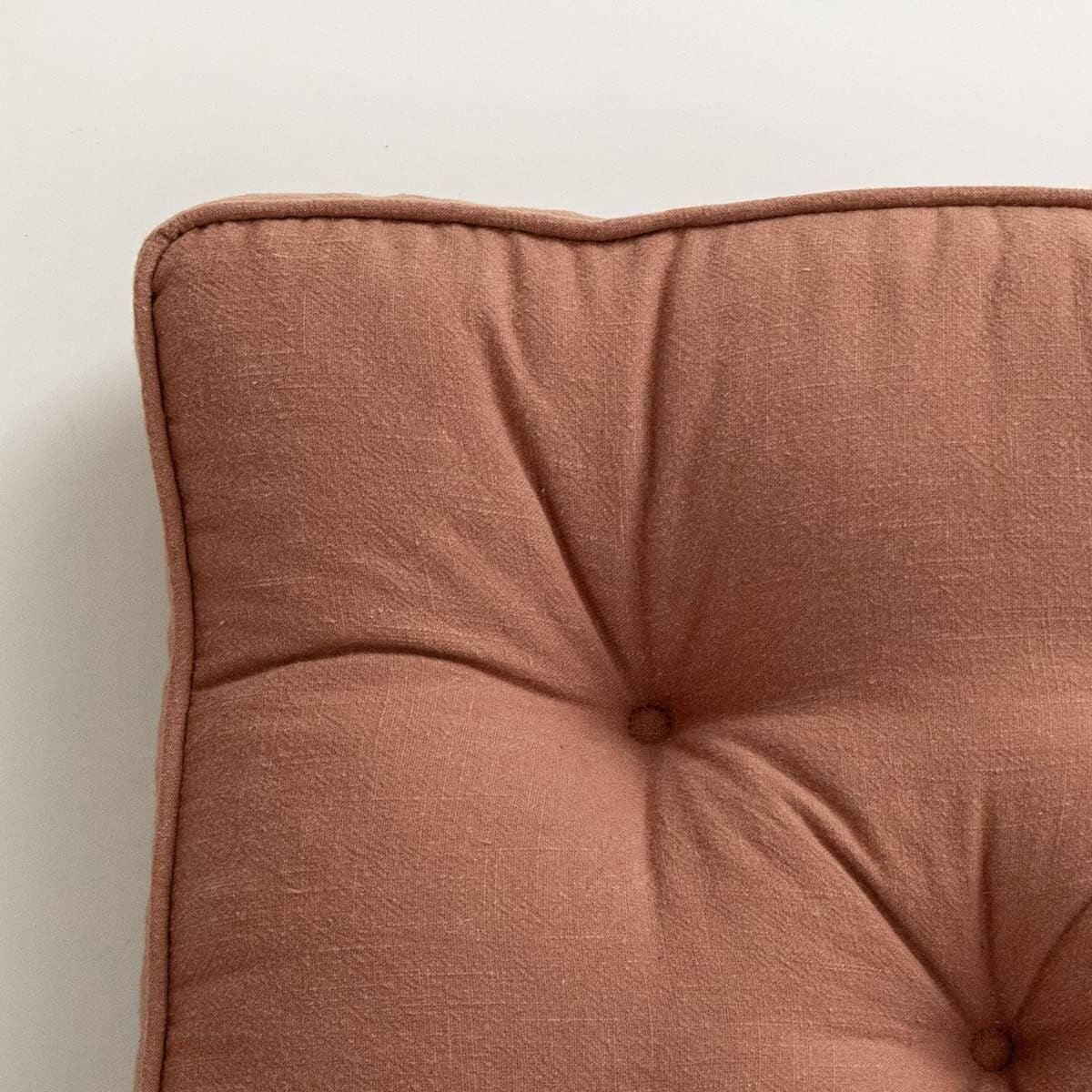 Close-up of a brown cushion on a light background