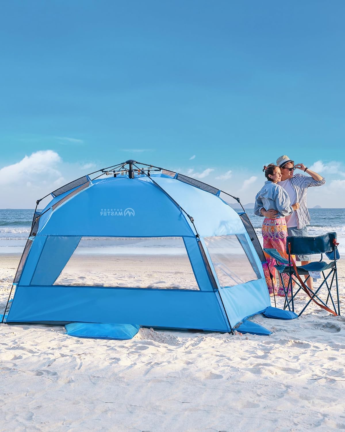 Blue beach tent on a sandy beach with a clear blue sky
