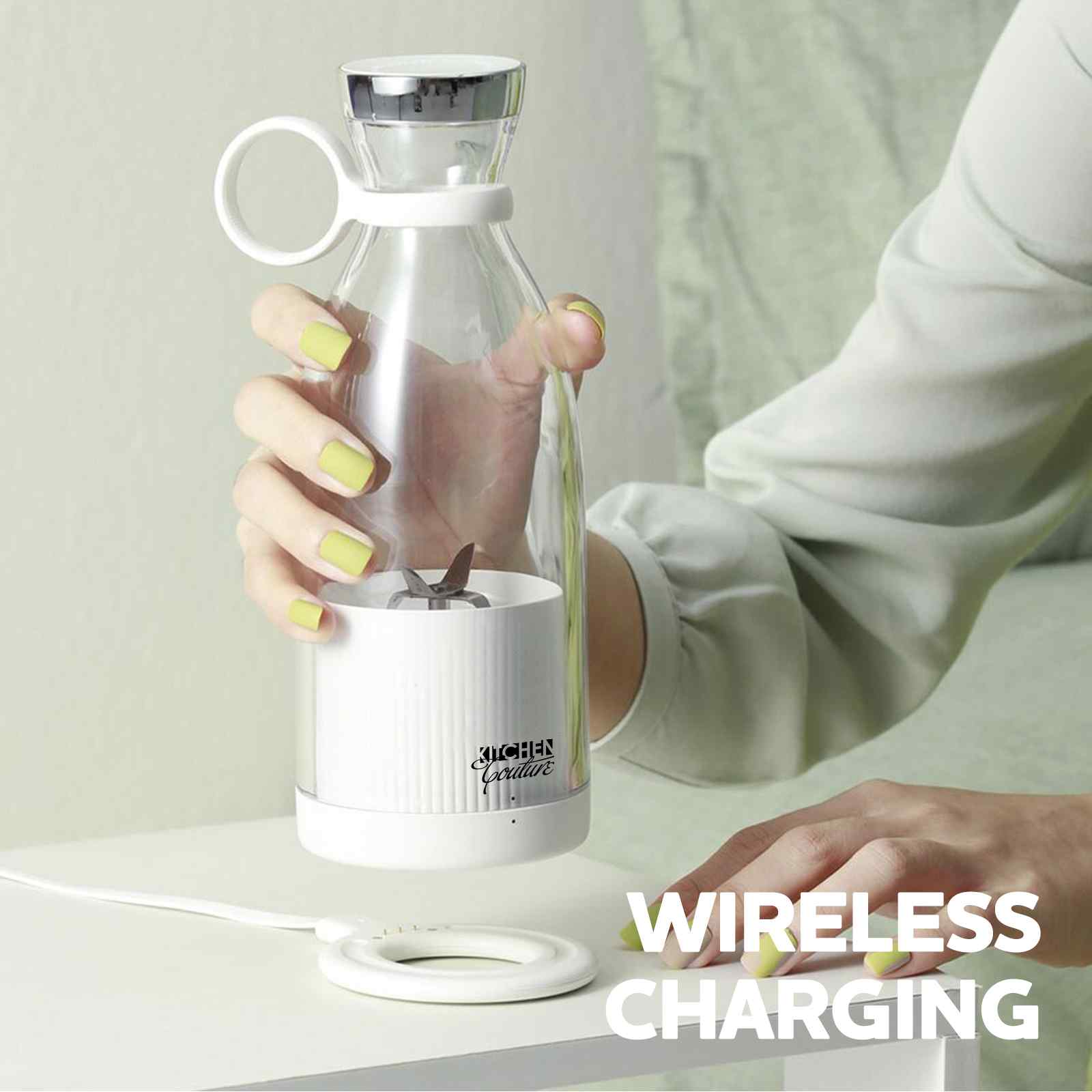 Person holding a wireless charging device with a clear carafe, on a light background.
