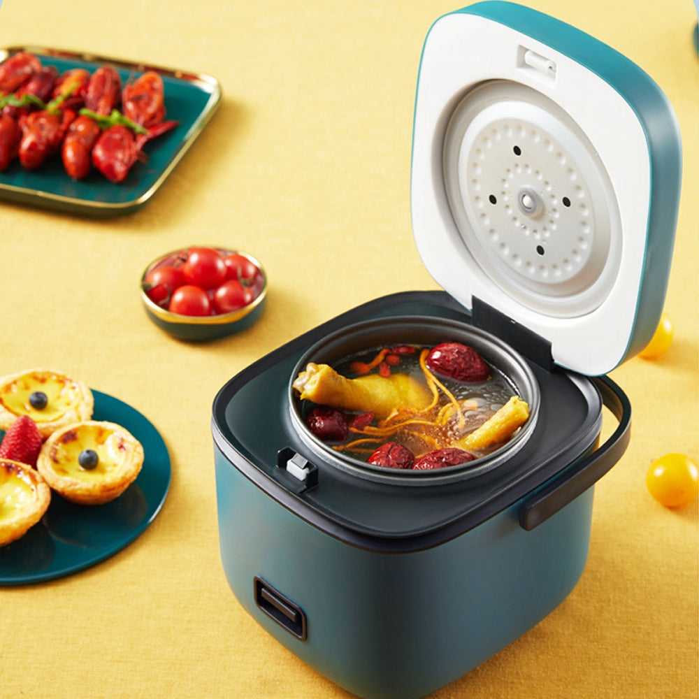 Small electric rice cooker with food on a yellow background