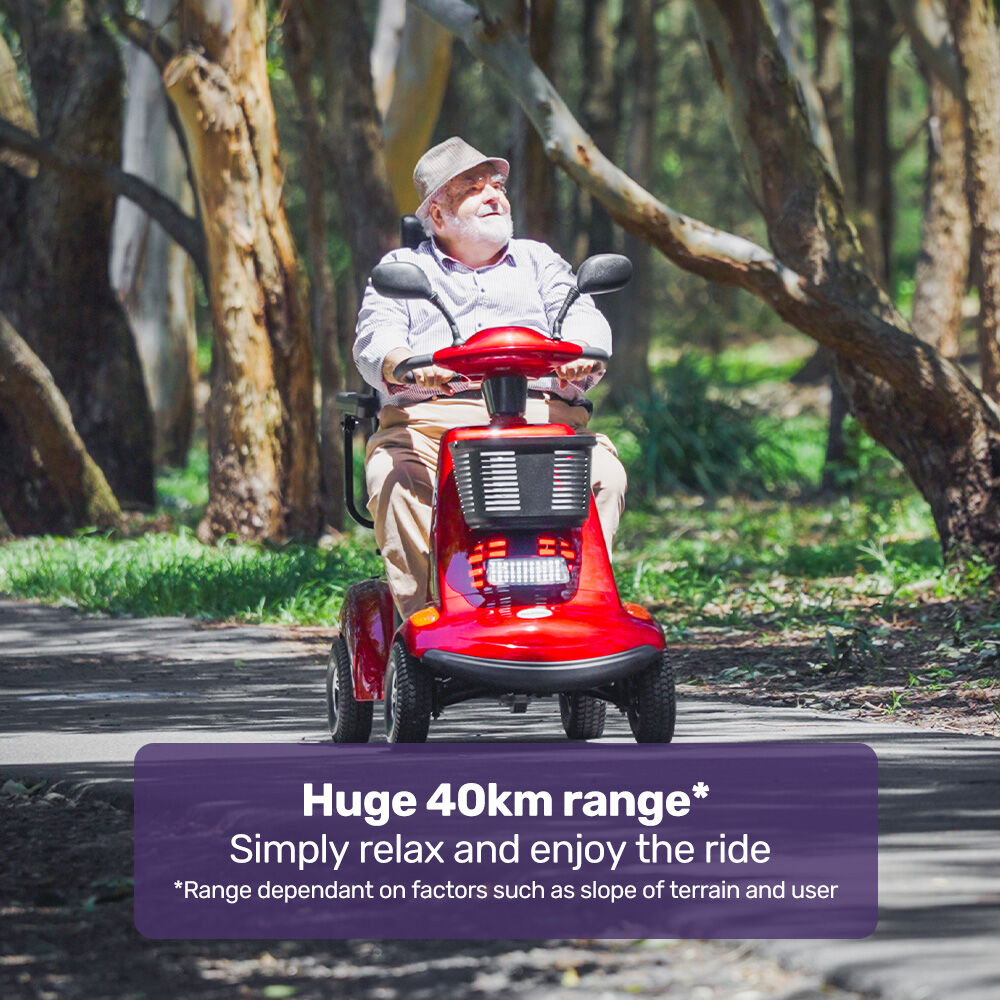 Man riding a red mobility scooter in a park with text about range and comfort.