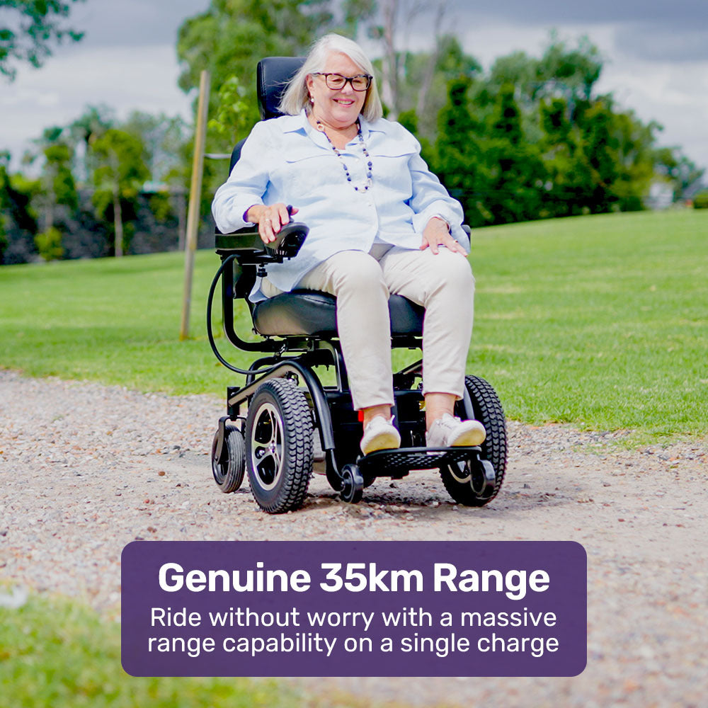 Person in a power wheelchair on a path with greenery in the background, featuring text about battery range.