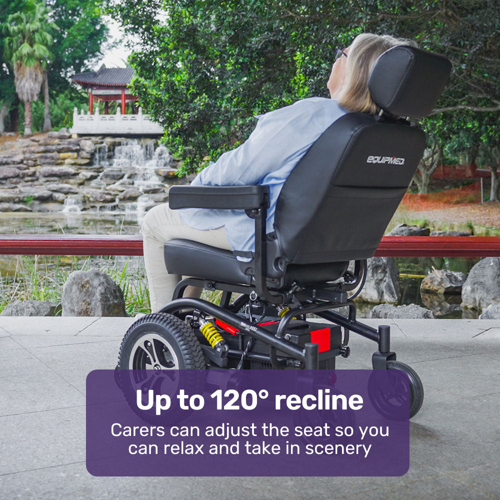 Person in a wheelchair with adjustable recline feature in a scenic outdoor setting