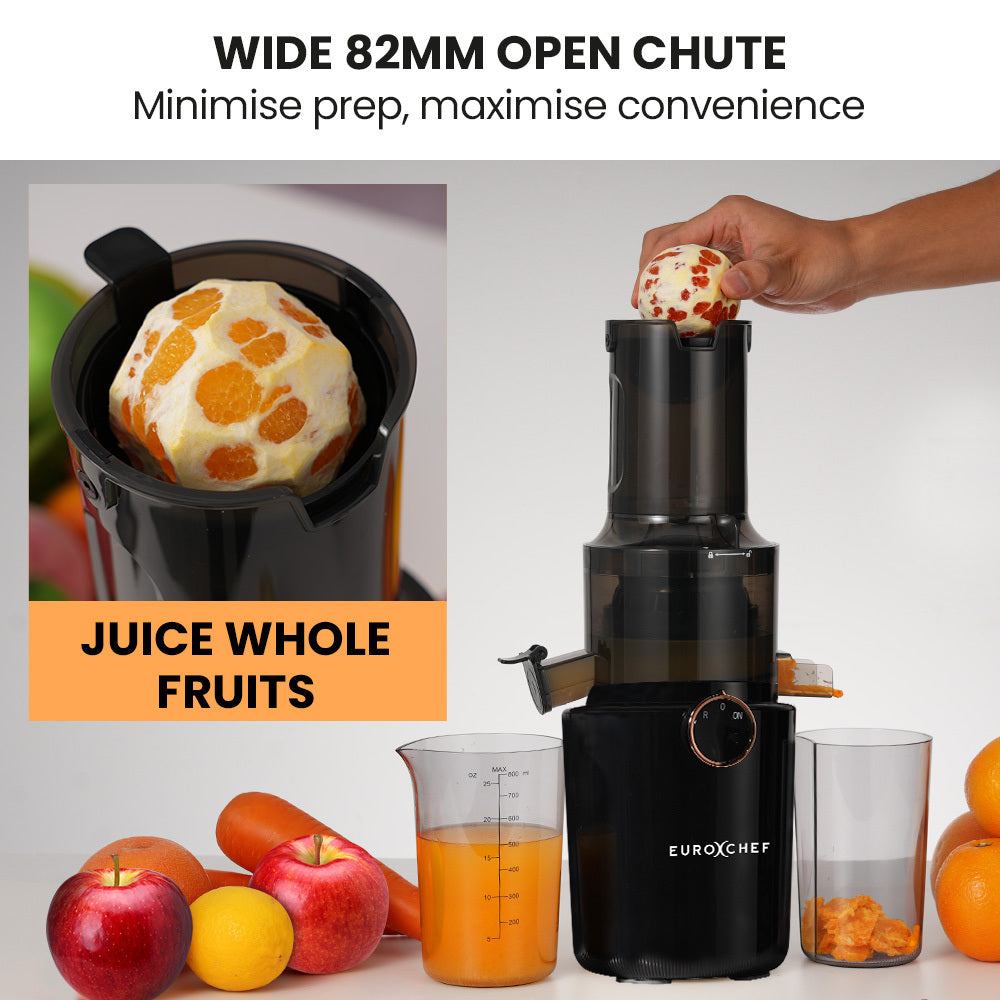 Black juicer with a wide 82mm open chute, surrounded by fruits and a glass of juice, with text highlighting its features.