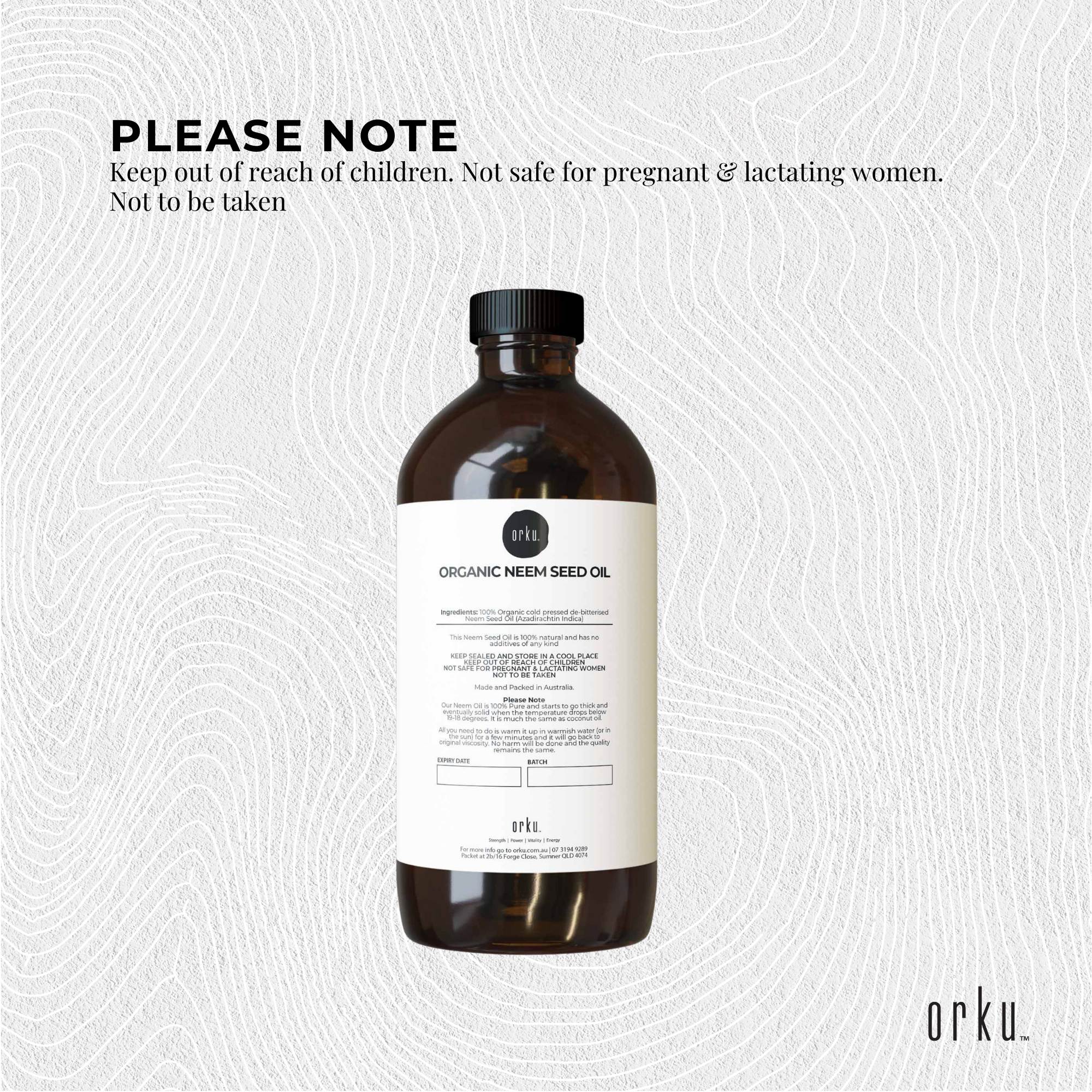 Bottle of organic neem seed oil with a label on a textured white background