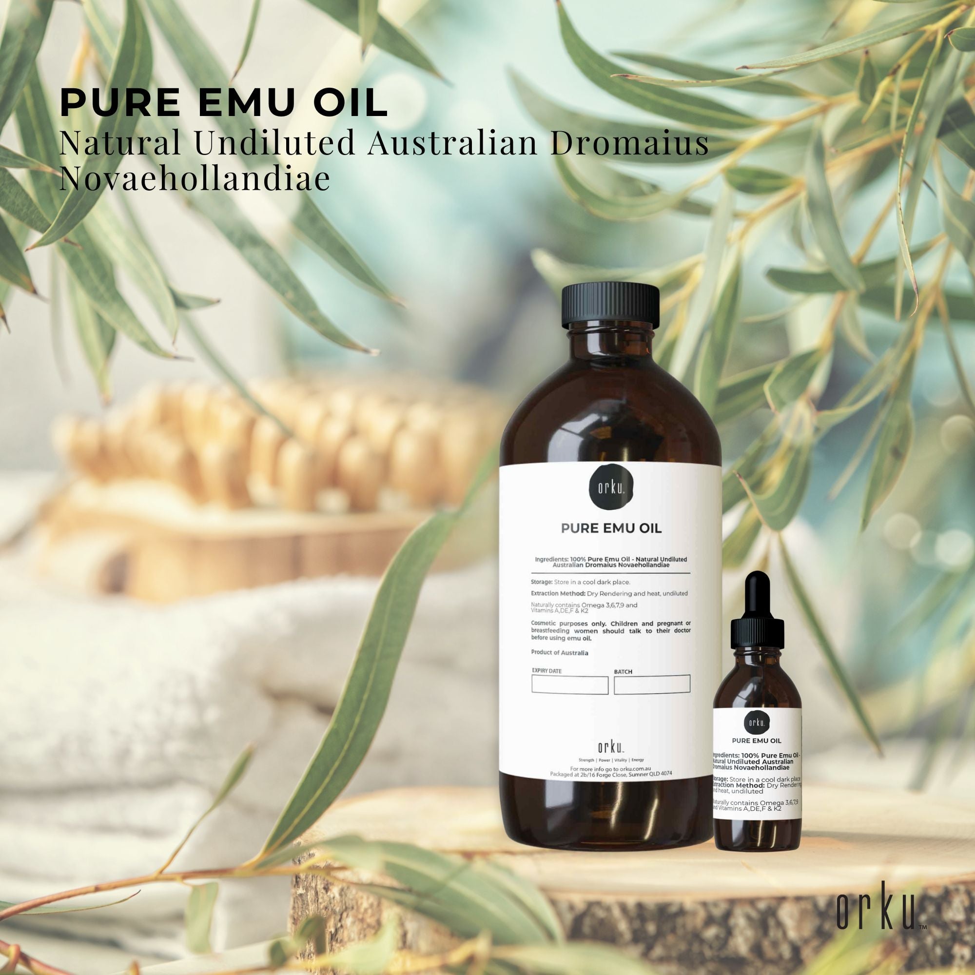 Two bottles of Pure Emu Oil with a label on a natural background with eucalyptus leaves.