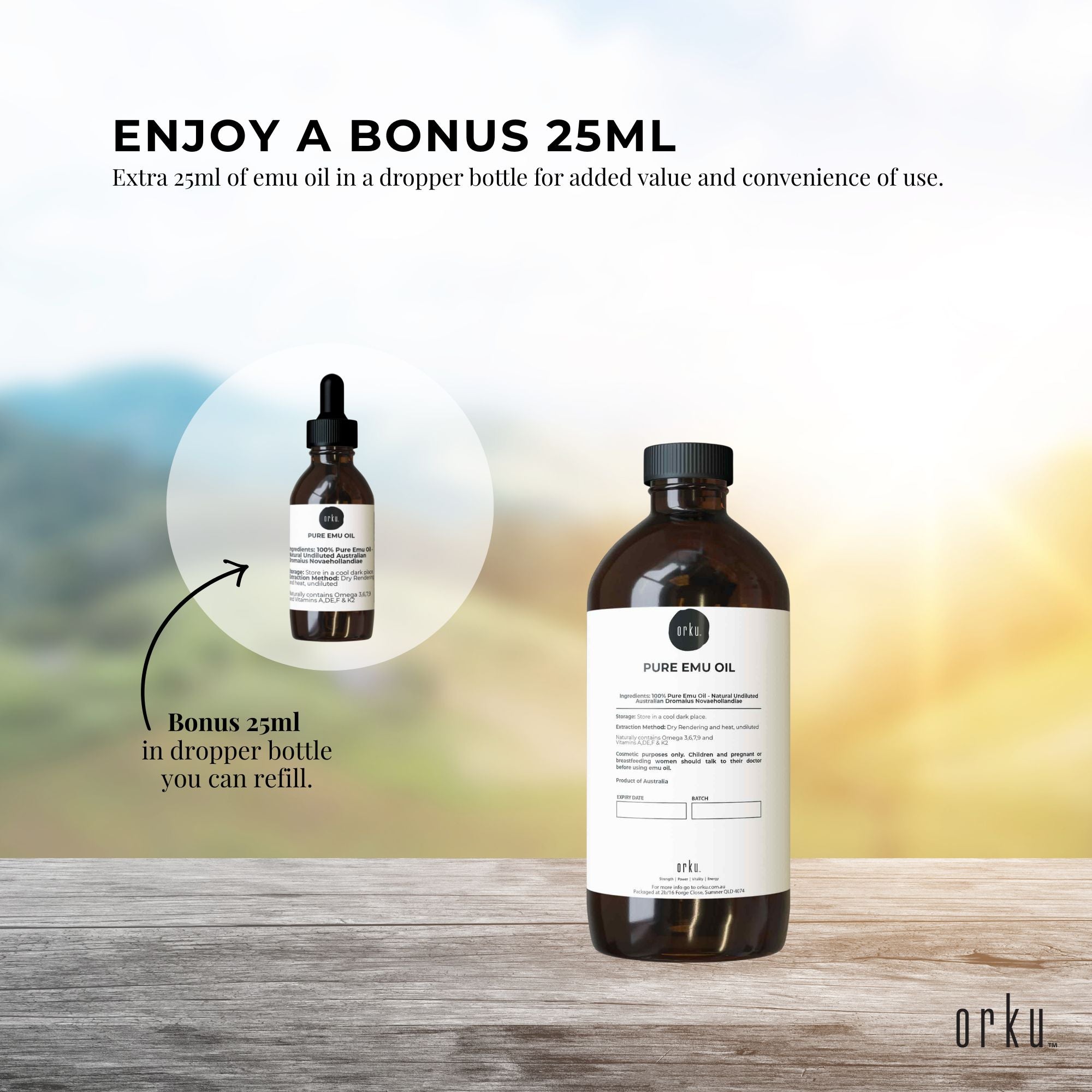 Two bottles of pure emu oil with a bonus 25ml dropper bottle on a wooden surface.