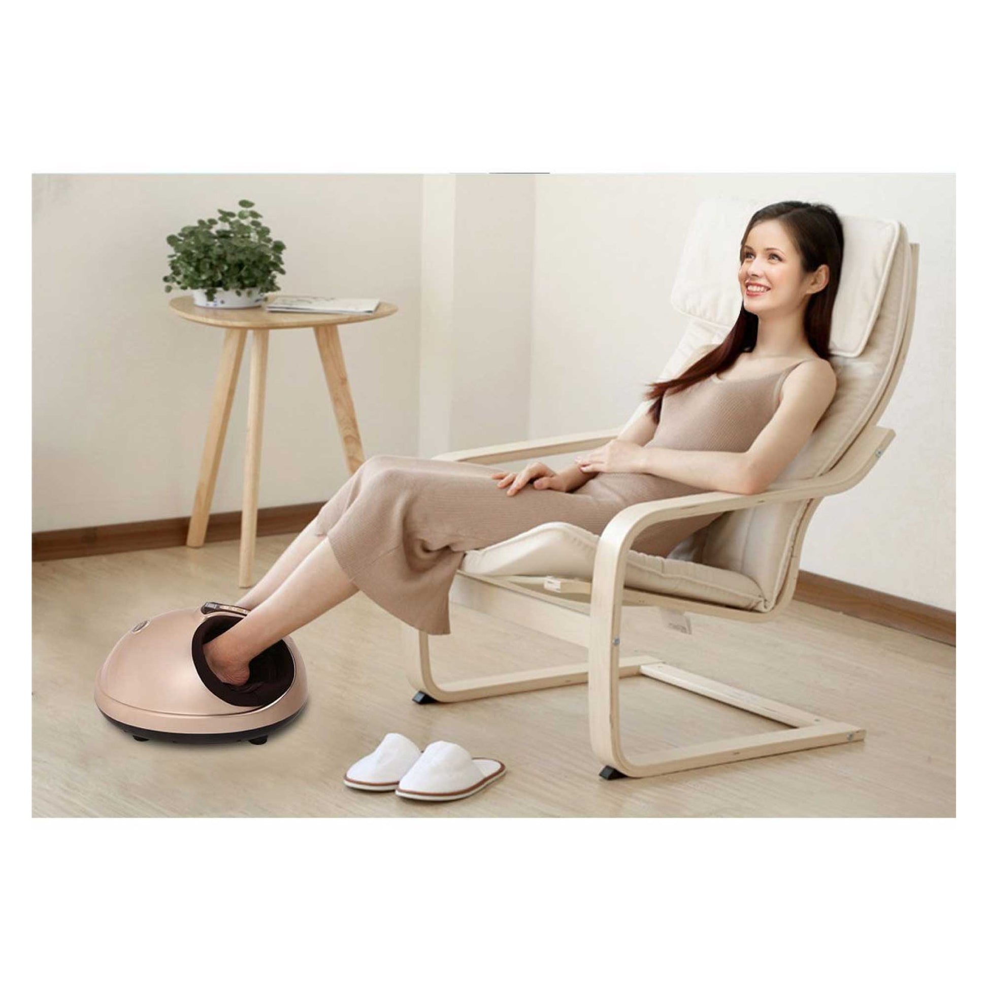 Woman using a foot massager in a modern room with a plant on a side table.