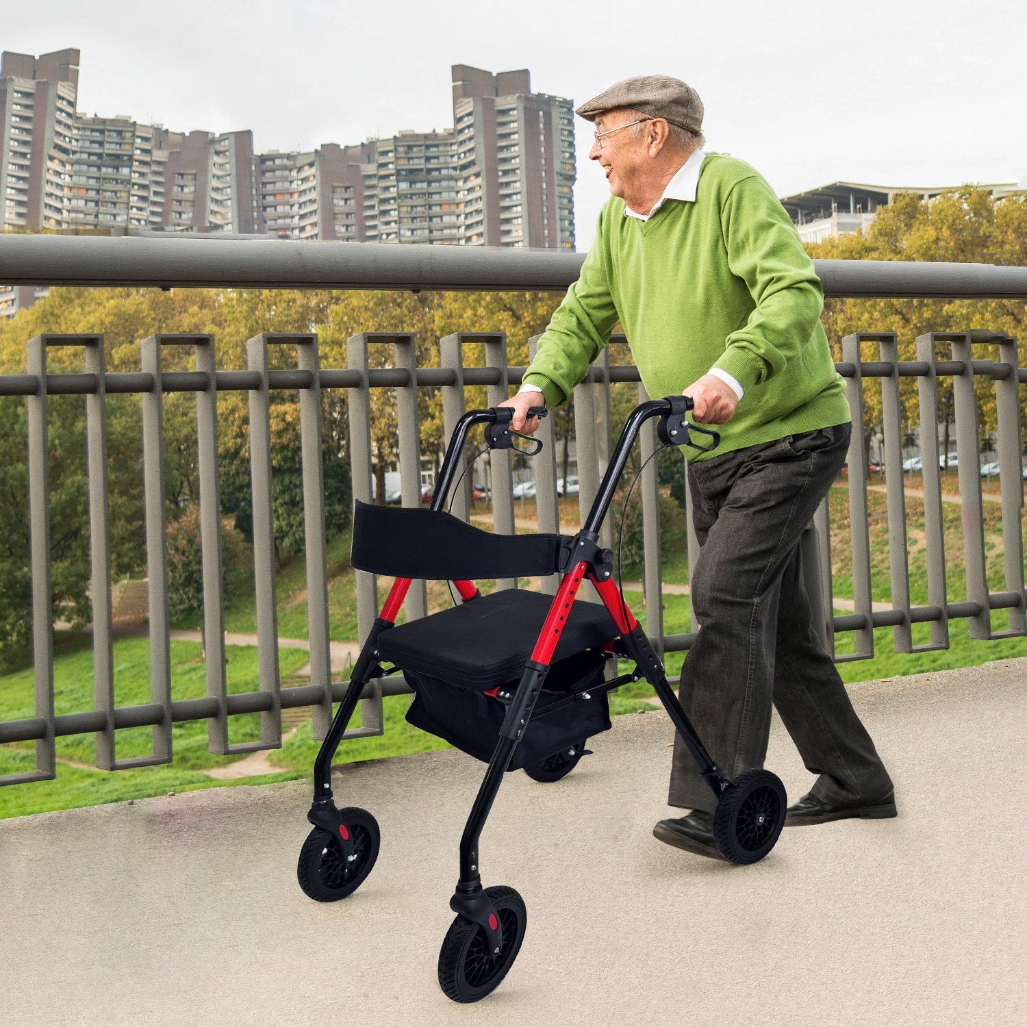 Man using a rollator on a sidewalk with buildings in the background