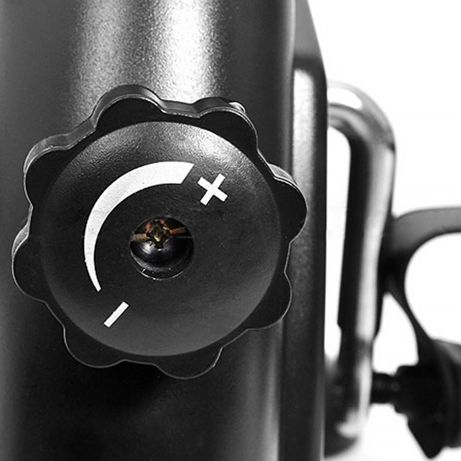 Close-up of a black adjustment knob on a metallic surface