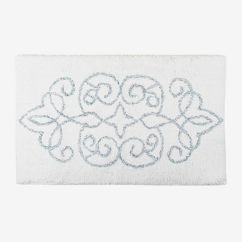 White bath mat with decorative blue pattern on a white background