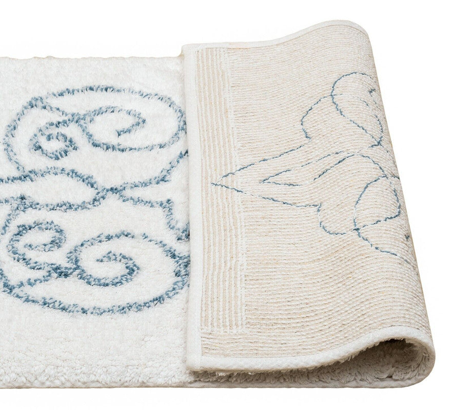 Folded towel with blue embroidered design on a white background